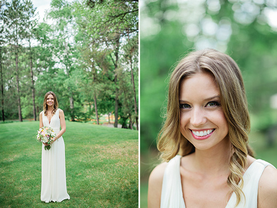 Beautiful bride in white dress holding bouquet smiling