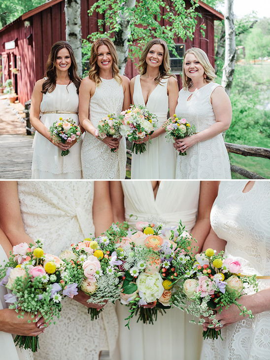 Bridesmaids in white dresses holding floral bouquets