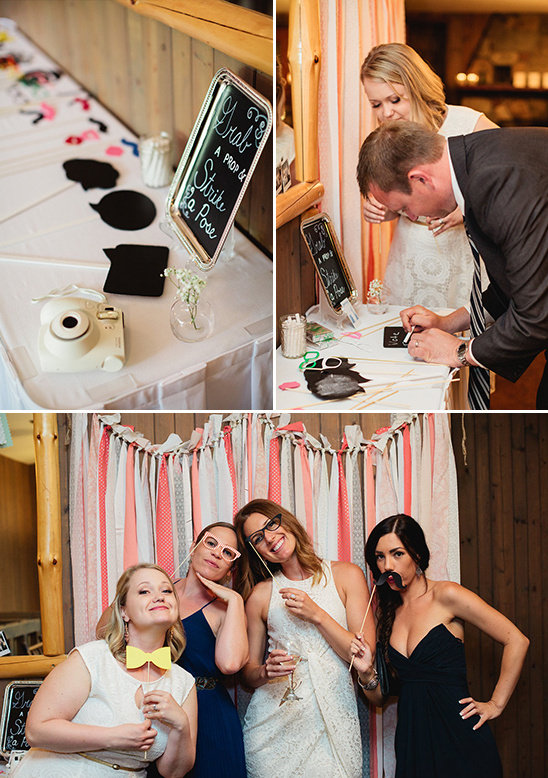 Wedding guests posing with photo booth props and smiling