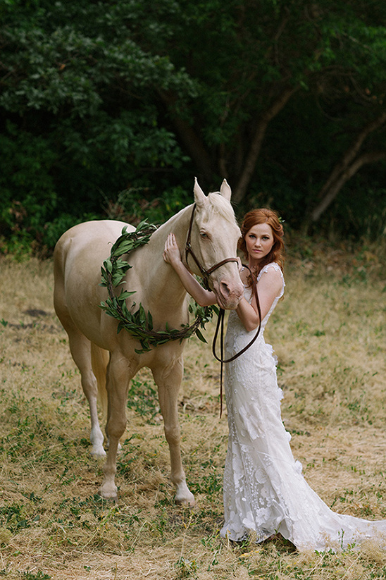 Woman in wedding dress with palomino horse outdoor