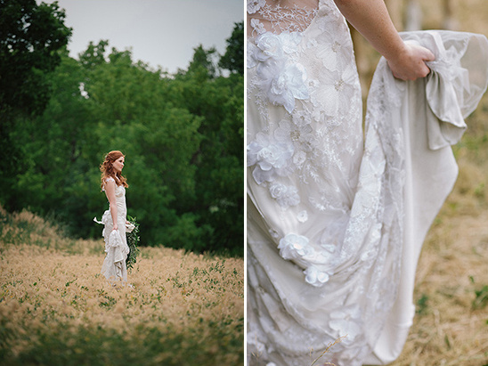 Bride in floral lace wedding dress standing in field