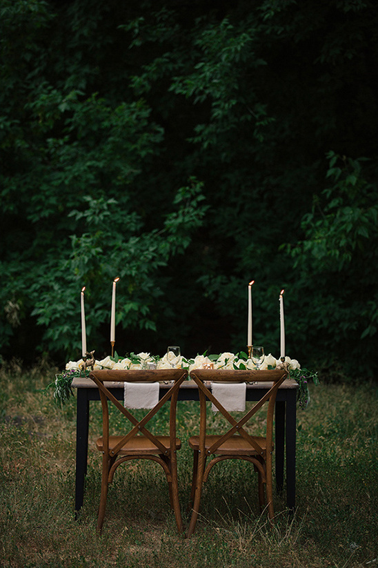 Outdoor wedding table setting with flowers and candles