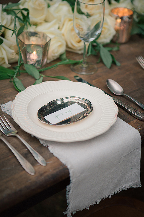 Elegant wedding table setting with roses candles and name card