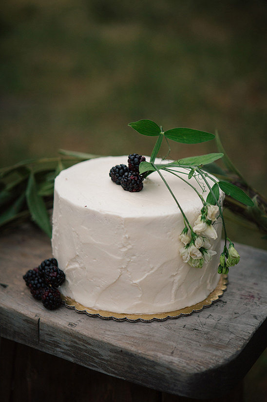 Rustic white cake with blackberries and white flowers