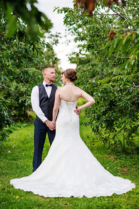 Loving wedding couple in garden looking at each other