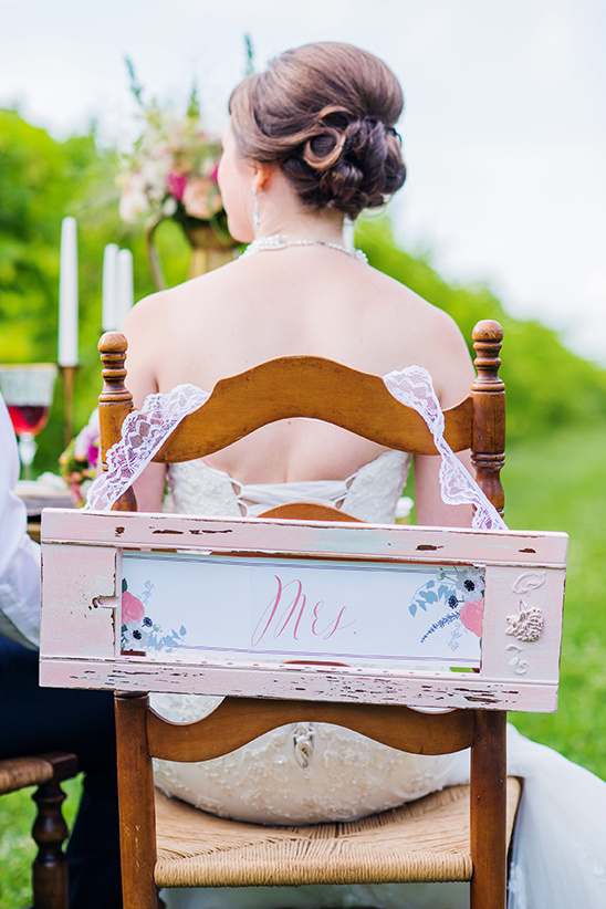 Bride back at outdoor wedding Mrs chair sign decor