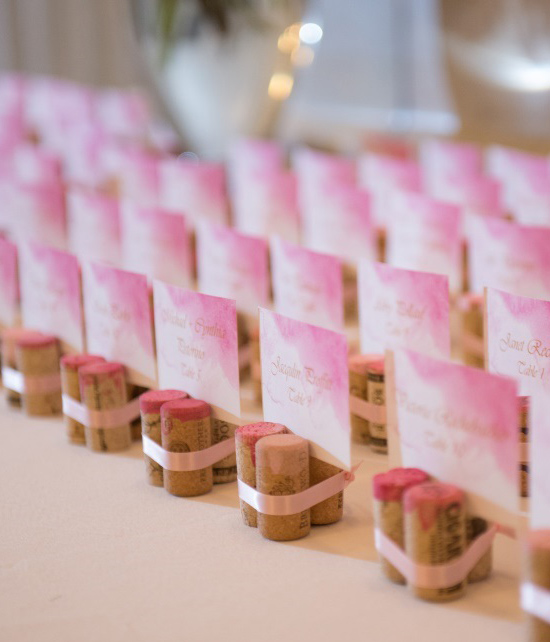 Pink watercolor wedding place cards in cork holders