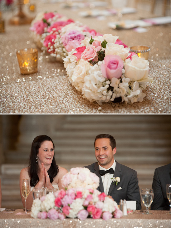 Wedding head table floral arrangement with happy couple