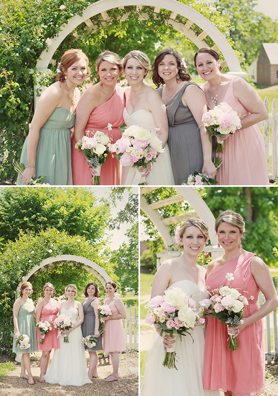Happy bridal party in pastel dresses with bouquets