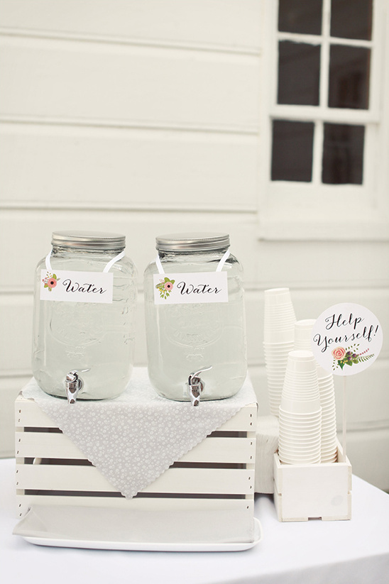 Rustic water station with glass dispensers and cups