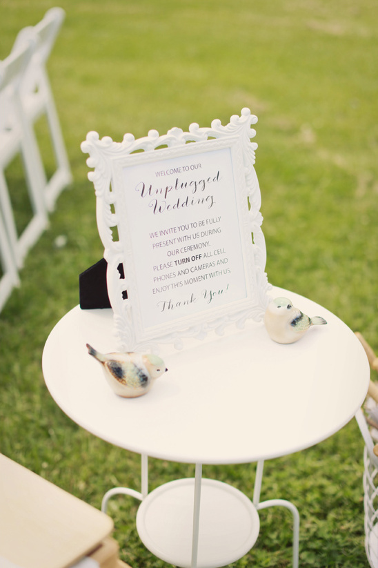 Unplugged wedding ceremony sign on table with birds