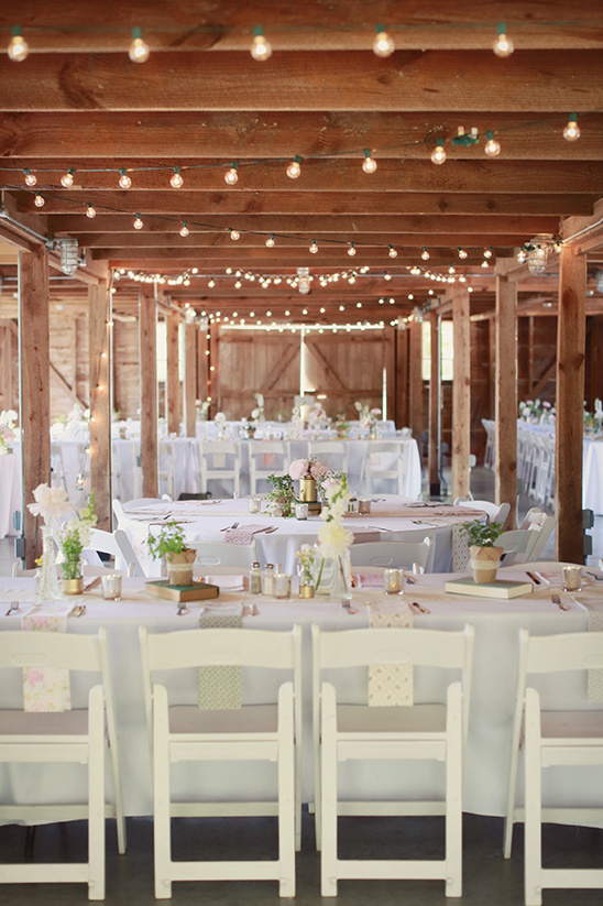 Romantic barn wedding reception with string lights
