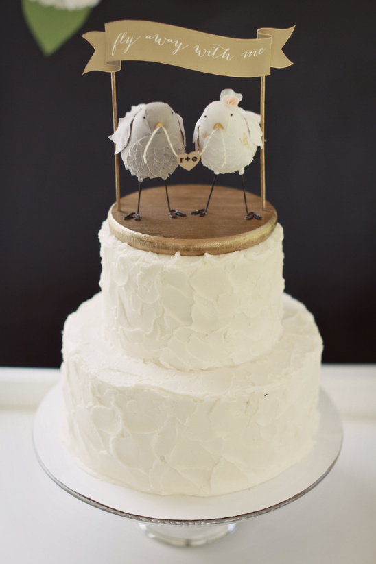Wedding cake with bird toppers and a fly away with me banner