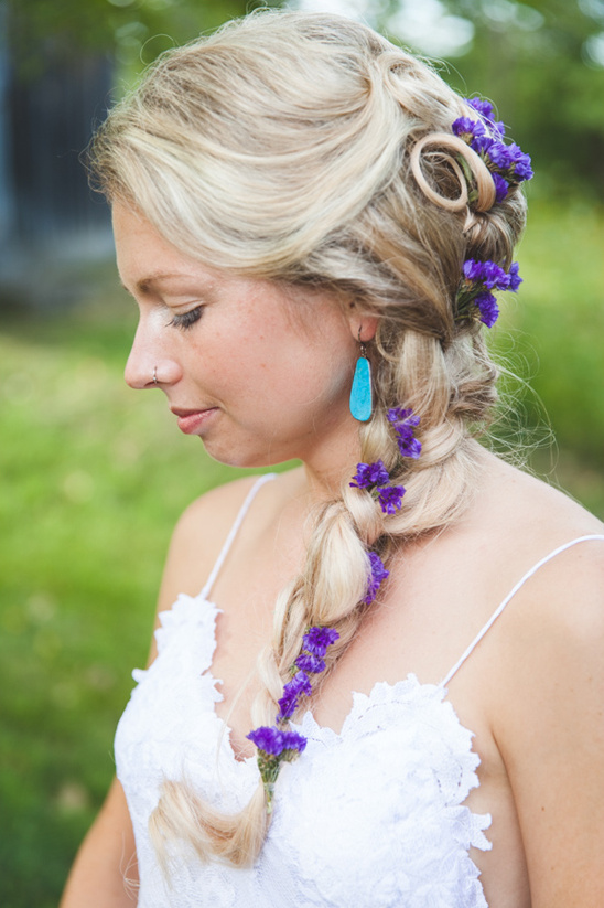 braided wedding hair with purple flowers