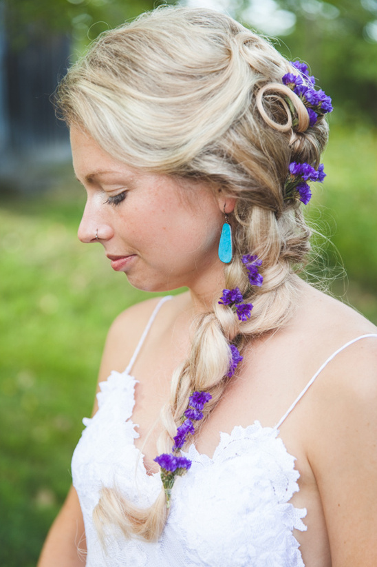Bride with blonde braid and purple flowers in hair