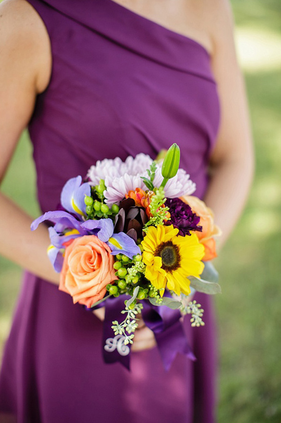bright bridesmaids bouquet pops against purple dress