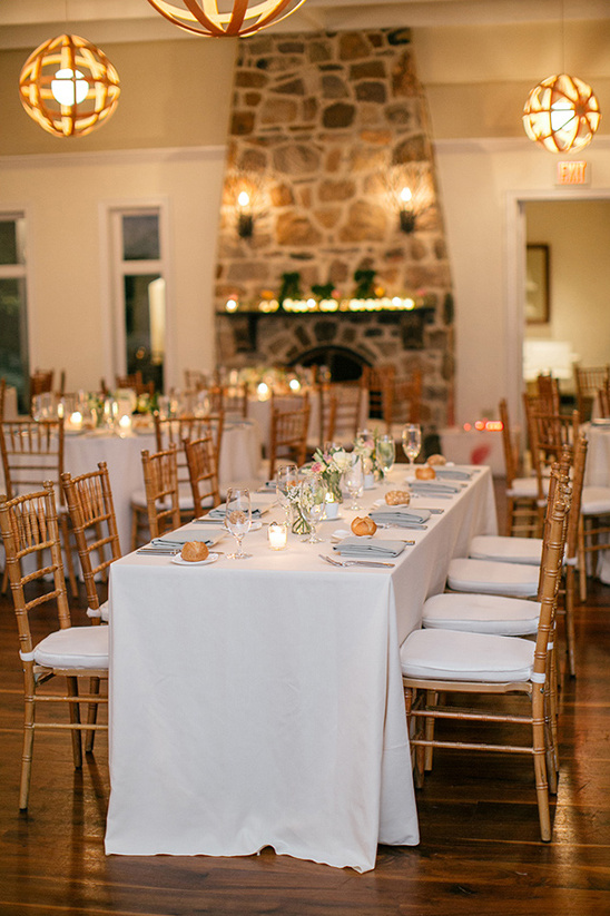 Elegant wedding reception tables and stone fireplace decor