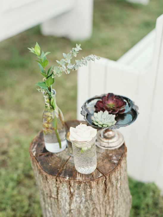 Rustic floral arrangement on wooden stump centerpiece