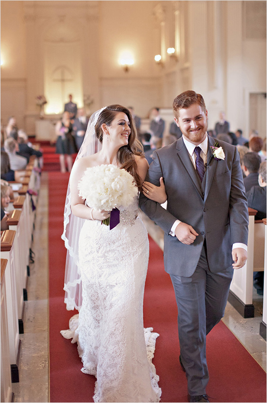 **Joyful bride and groom walk church aisle after wedding**