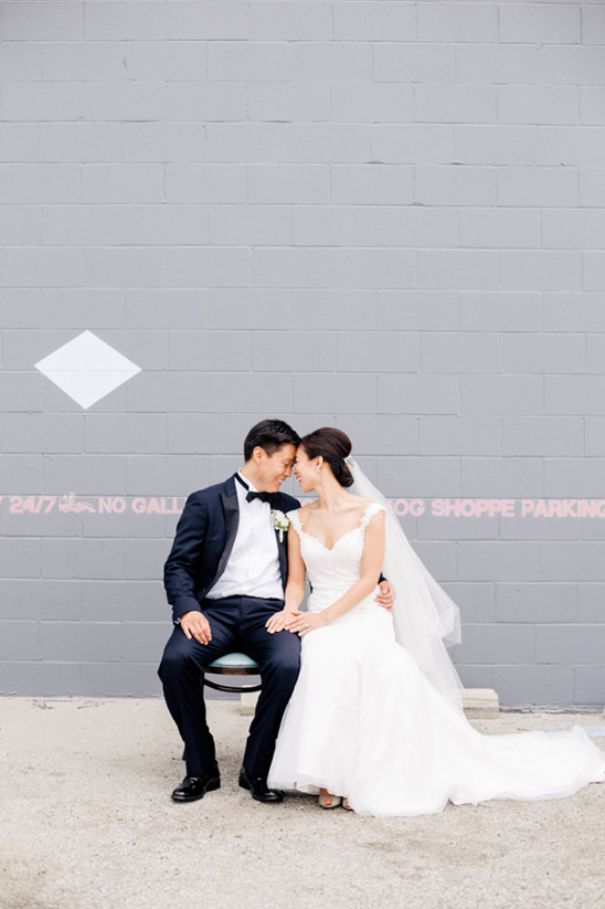 Elegant Asian couple in wedding attire posing outdoors