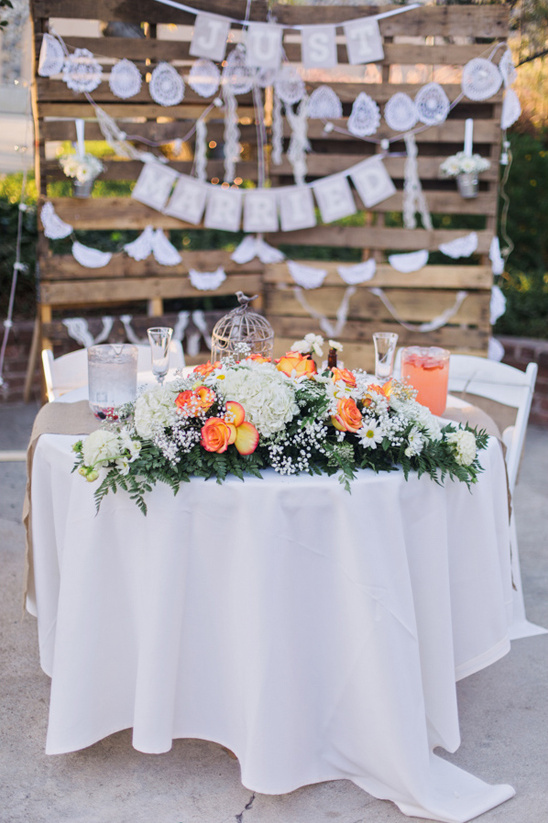 Just Married table decor rustic wood backdrop flowers