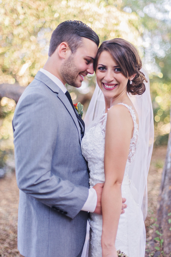 Smiling bride and groom embrace on their wedding day