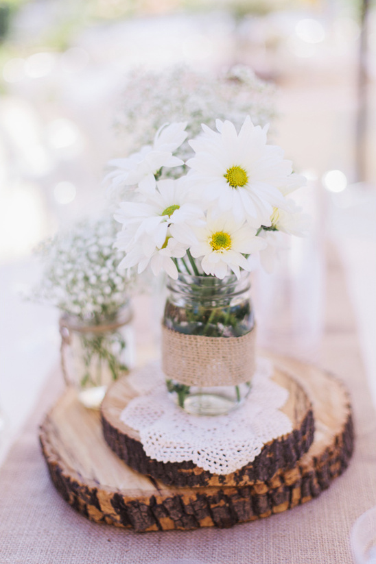 Rustic wedding centerpiece: white daisies in mason jars