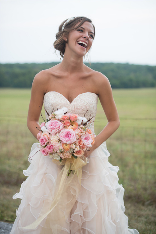 romantic bridal attire with pink bouquet