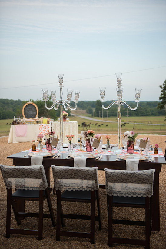 Rustic outdoor wedding table setting with candelabras