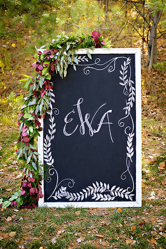 Decorated chalkboard with EWA calligraphy outdoors