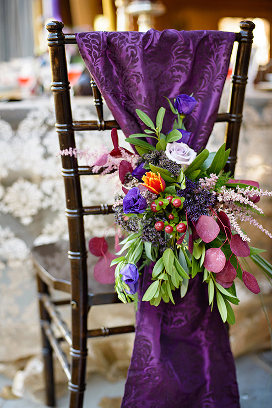 Elegant chair decoration with flowers and purple fabric