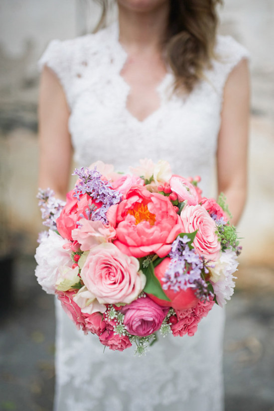 Bride holding beautiful pink wedding flower bouquet
