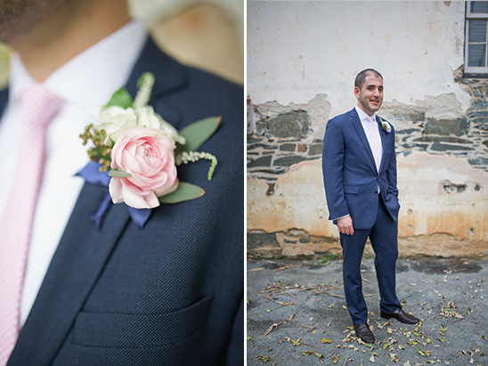 Groom in blue suit pink tie and boutonniere flowers