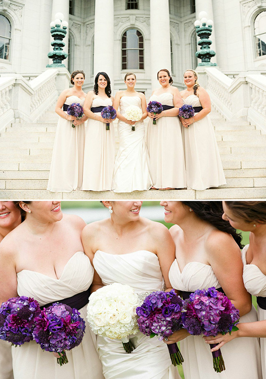 Smiling bride and bridesmaids with purple bouquets