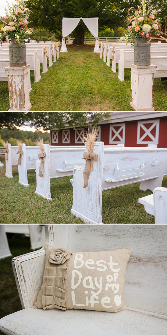 Rustic outdoor wedding venue with white benches and flowers