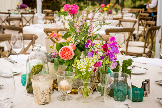 Elegant outdoor table with vibrant floral wedding centerpiece