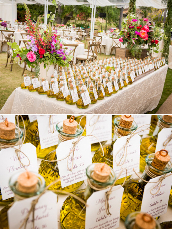 Rows of olive oil guest favors at a wedding reception