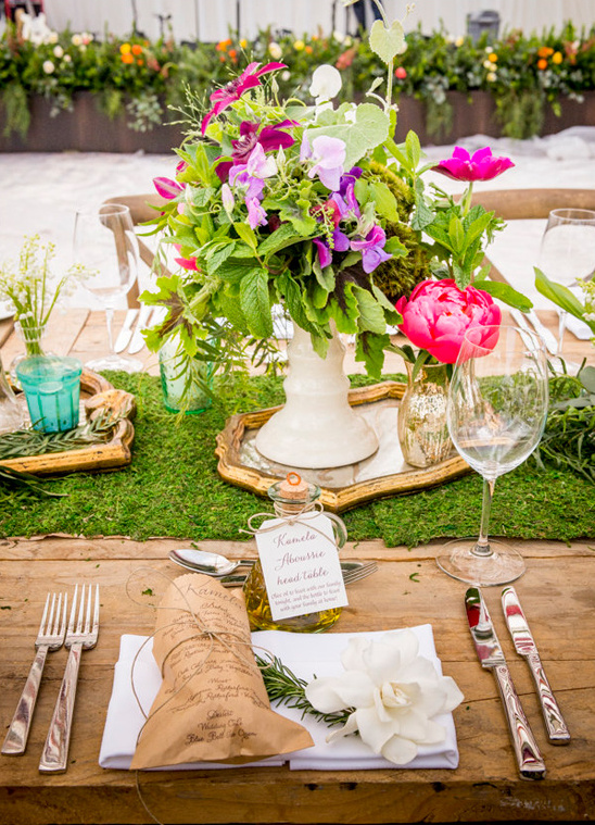 Chic outdoor wedding table with vibrant floral centerpiece