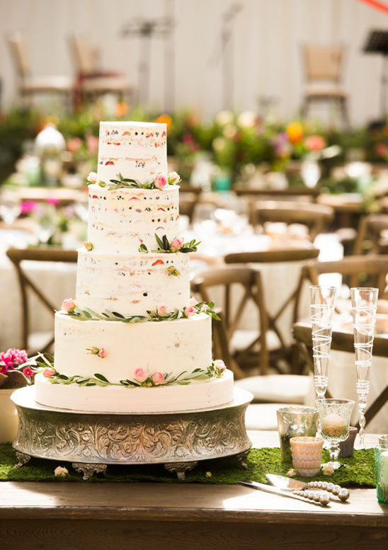 Beautiful four tier naked wedding cake with floral decor