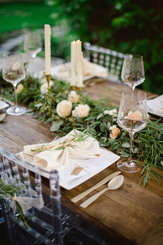 rustic wood table with greenery swag runner
