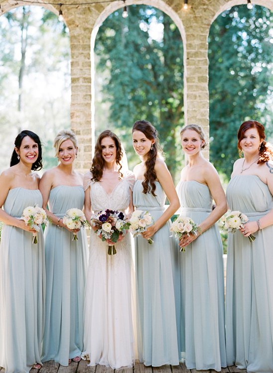 Bride and bridesmaids in light blue dresses at wedding