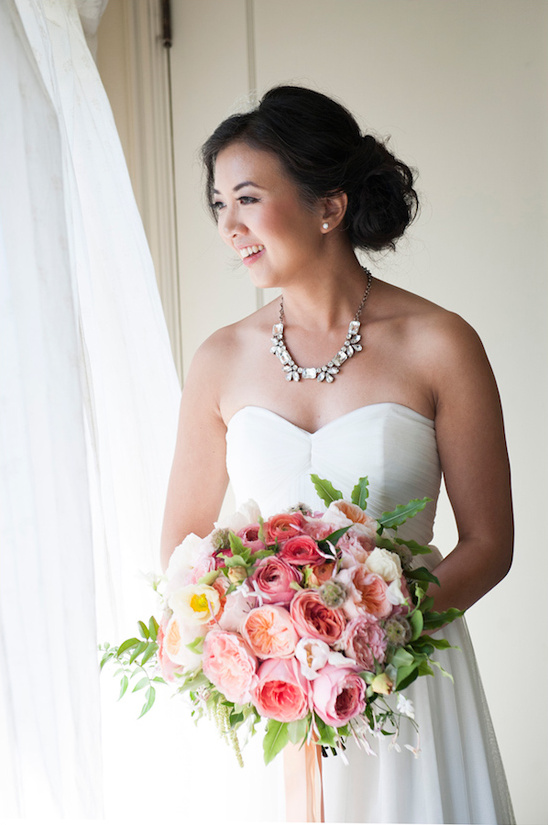 Radiant bride holding a beautiful pink wedding bouquet