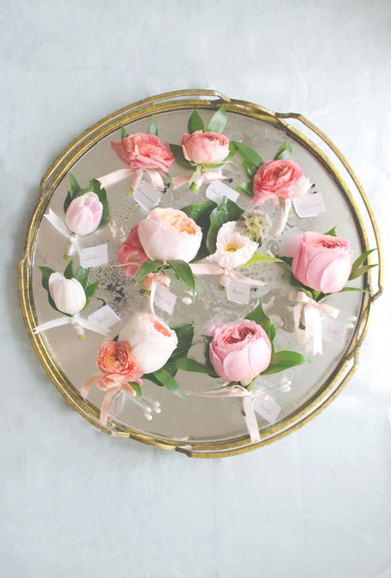 Floral wrist corsages on a vintage mirrored serving tray