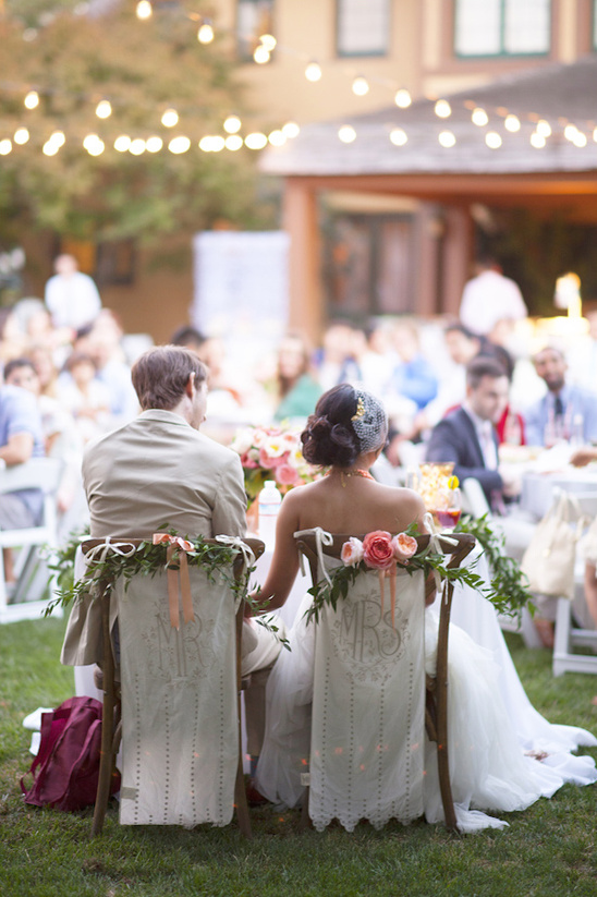 Bride and groom at outdoor wedding reception table