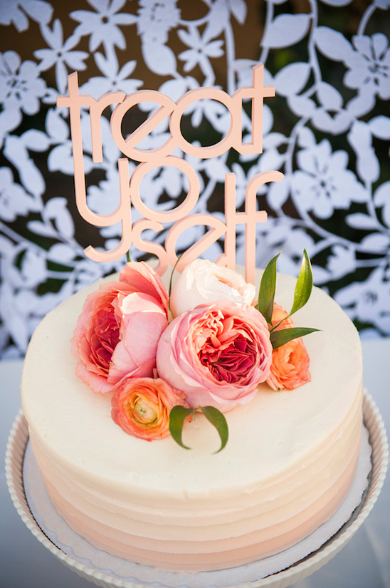 Cake with treat yourself topper and pink flowers