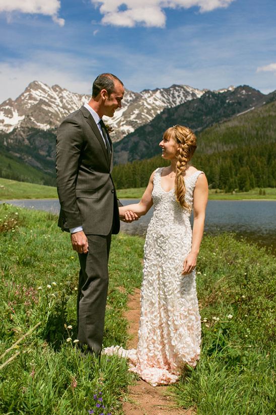 Happy couple holding hands, mountain wedding ceremony