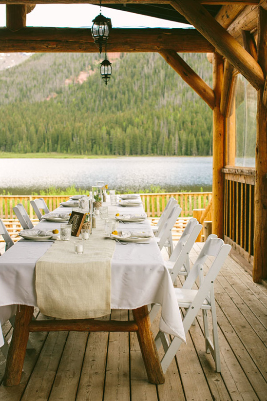 Wedding reception table on a porch overlooking the lake