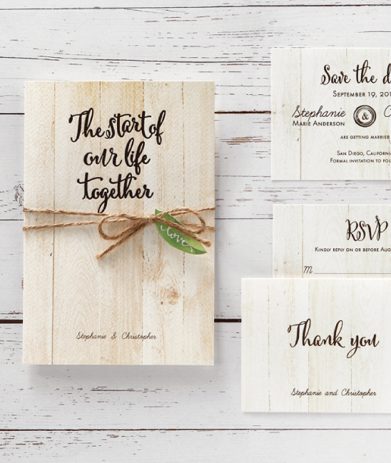 Rustic wedding invitations with wood texture and twine
