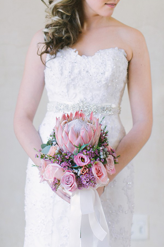 Bride holding a beautiful pink and purple wedding bouquet