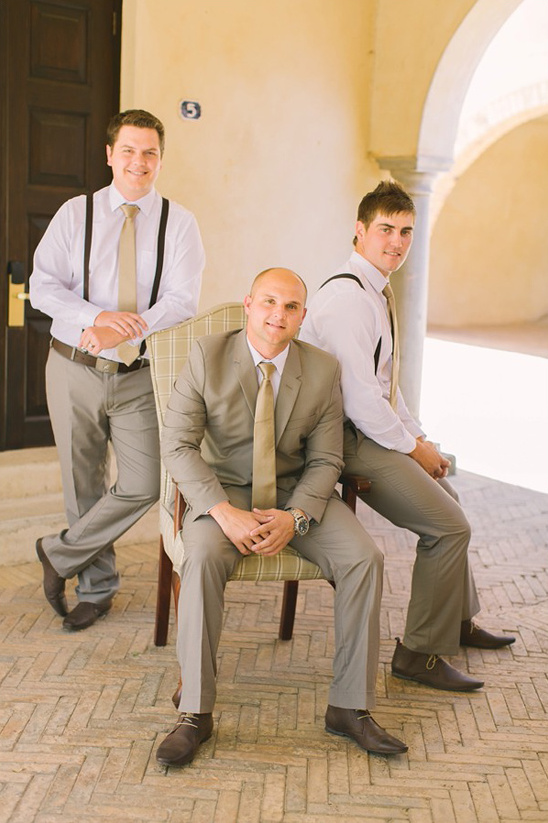 Groomsmen in matching suits posing confidently for a photo